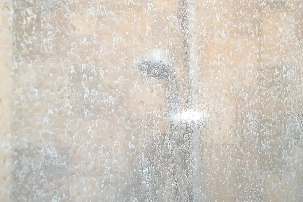 Hard water causing limescale on a shower screen