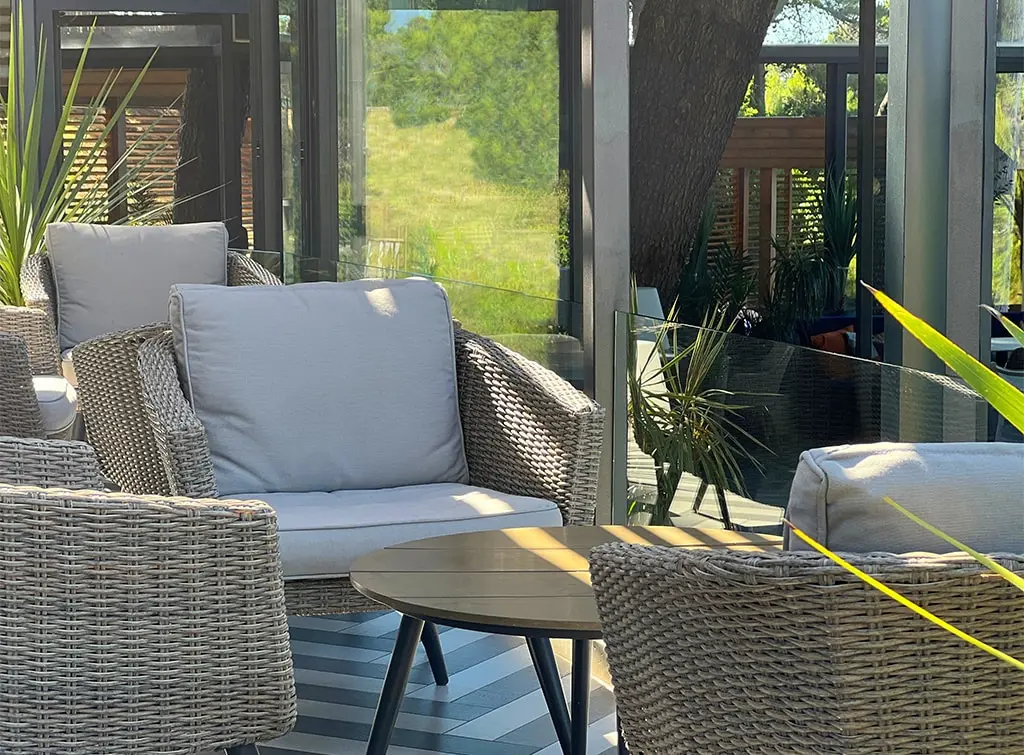 https://www.checkatrade.com/blog/wp-content/uploads/2023/08/orangery-rattan-furniture.jpg