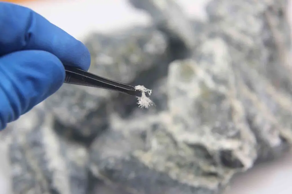 Tradesperson showing asbestos fibres