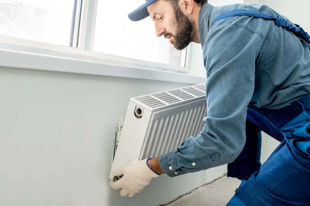 tradesperson replacing a radiator