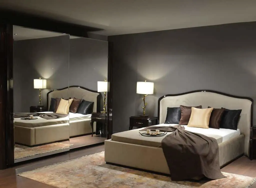 https://www.checkatrade.com/blog/wp-content/uploads/2024/02/Dark-luxe-bedroom-with-fitted-wardrobe-and-mirrors.jpg