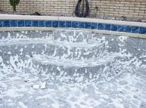 Swimming pool with tiles removed - concrete pool resurfacing cost