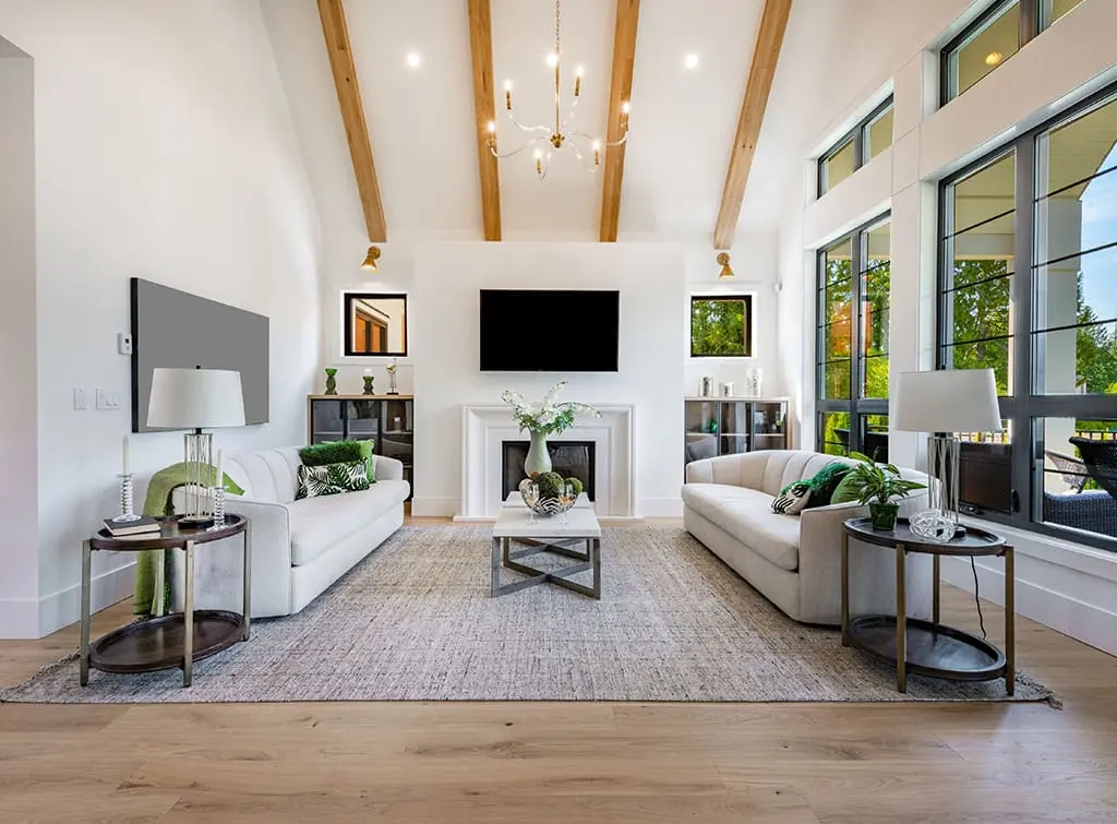 Vaulted ceiling and large windows in a light living room
