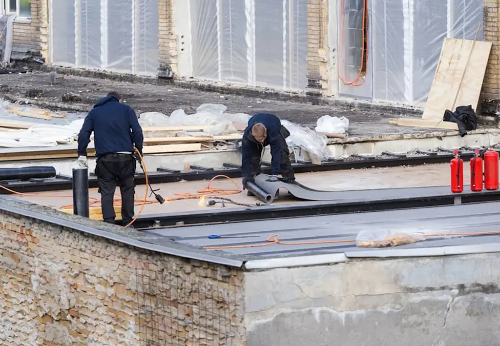 Flat roof being repaired
