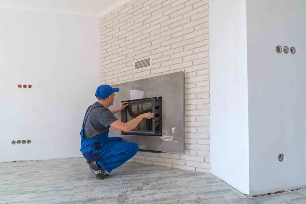 Gas engineer working on a gas fire inside a home