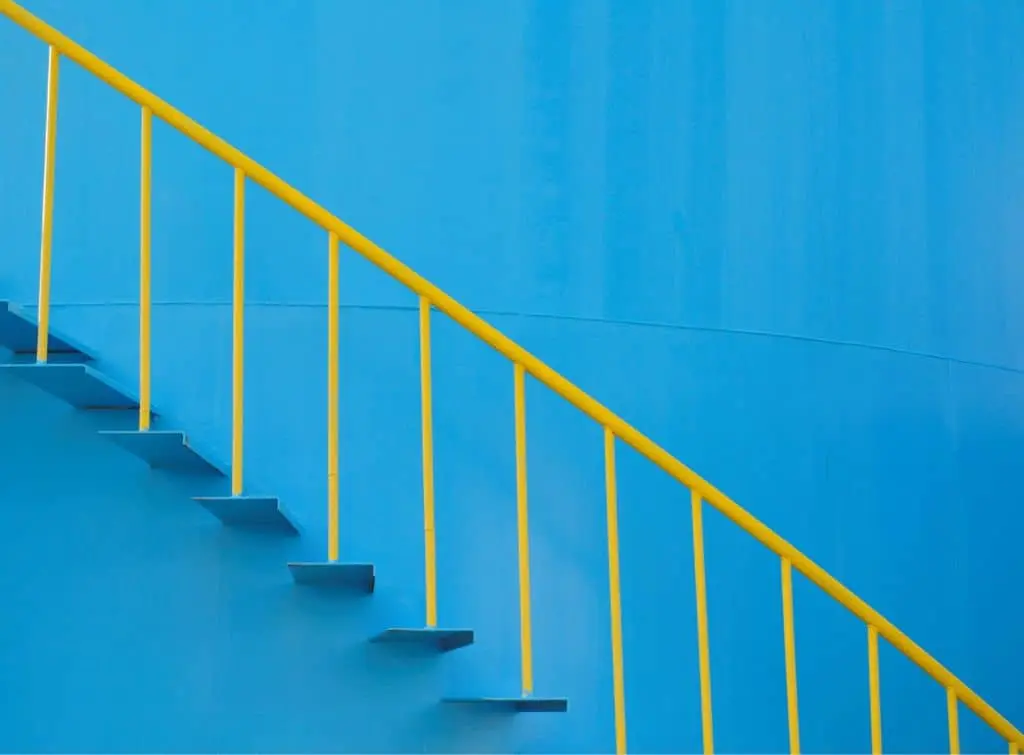Yellow banister on blue floating stairs