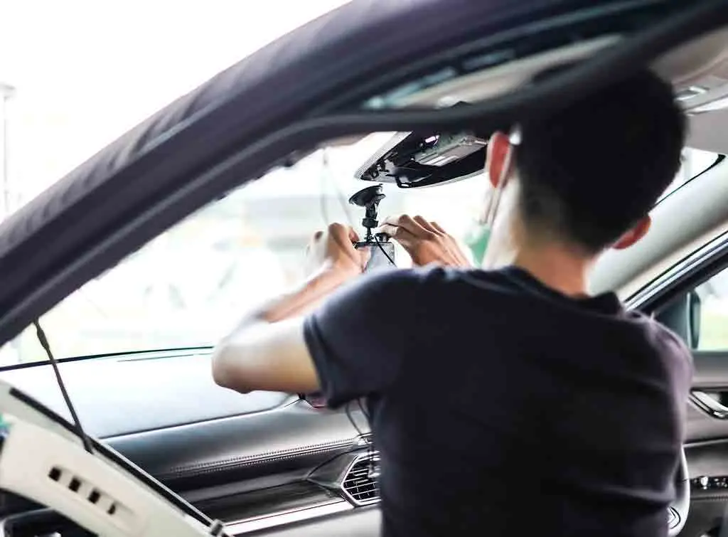 Person installing a dash cam