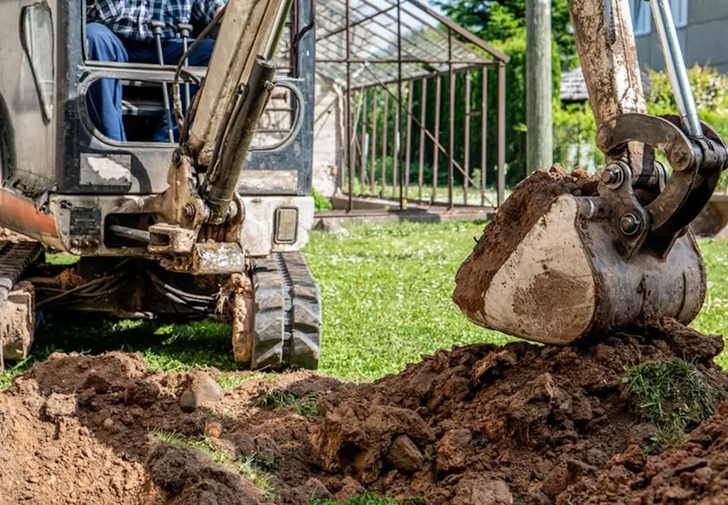 Mini digger levelling garden