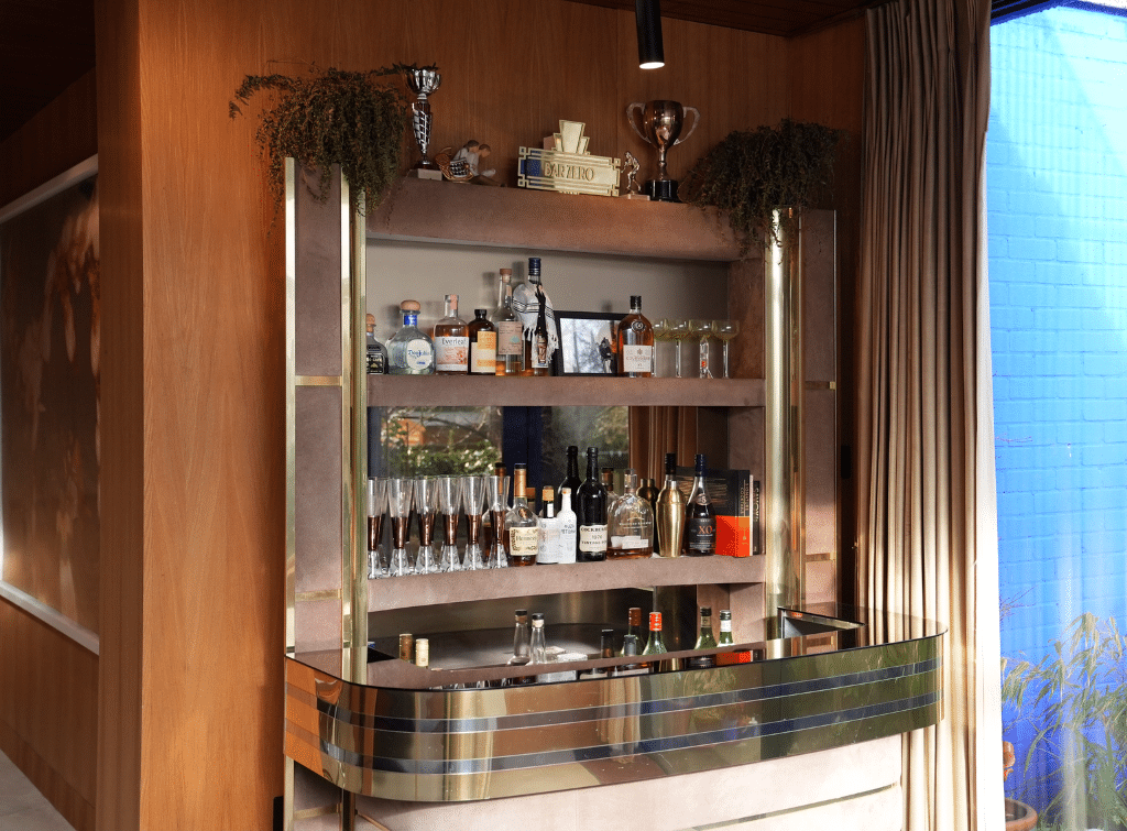 A glass drinks bar against wood panelled walls