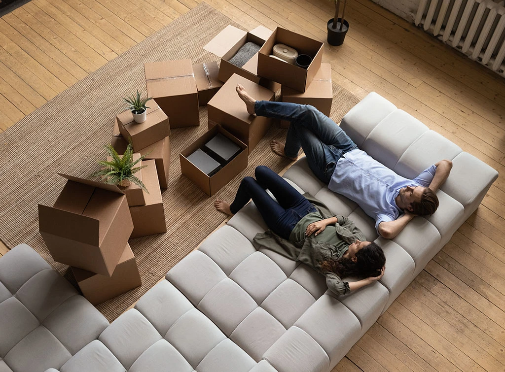 couple moving apartment surrounded by boxes