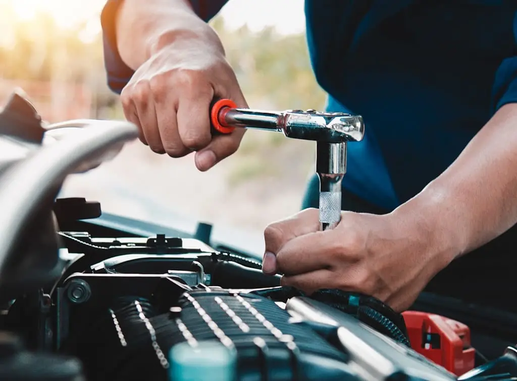 Mobile mechanic working on a car