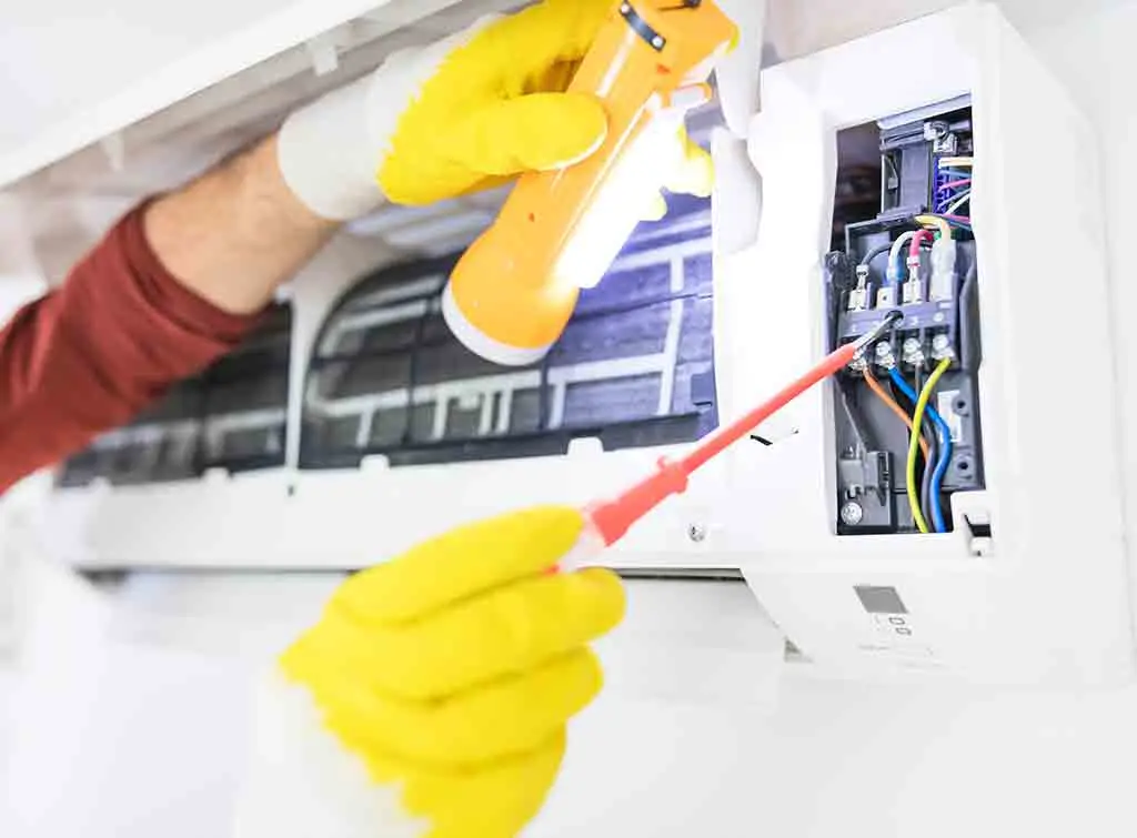 air con specialist servicing a unit