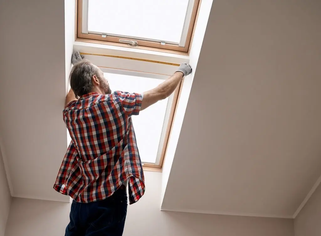 https://www.checkatrade.com/blog/wp-content/uploads/2025/02/tradesperson-measuring-for-velux-window-skylights.jpeg