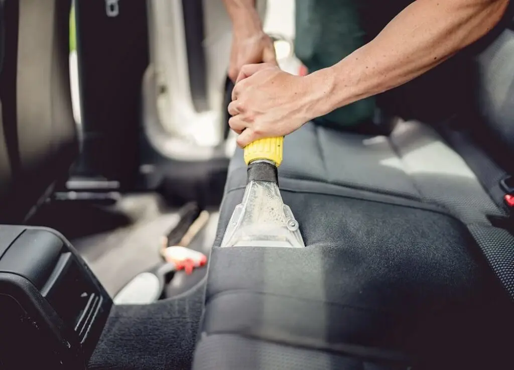 https://www.checkatrade.com/blog/wp-content/uploads/2025/03/cleaning-car-seat-as-part-of-valet-1024x737.jpeg