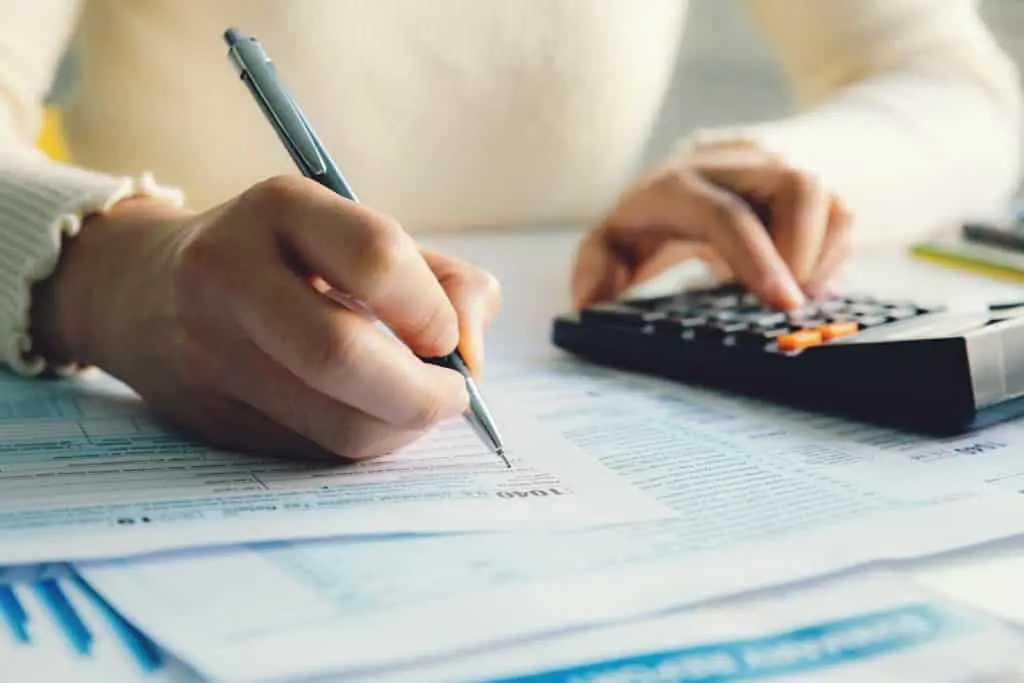 how to file business taxes - adding up figures on a calculator