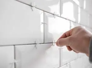 Tile spacers inbetween white subway tiles