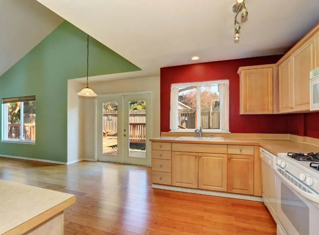 Mint green and red accents walls in minimalist kitchen area