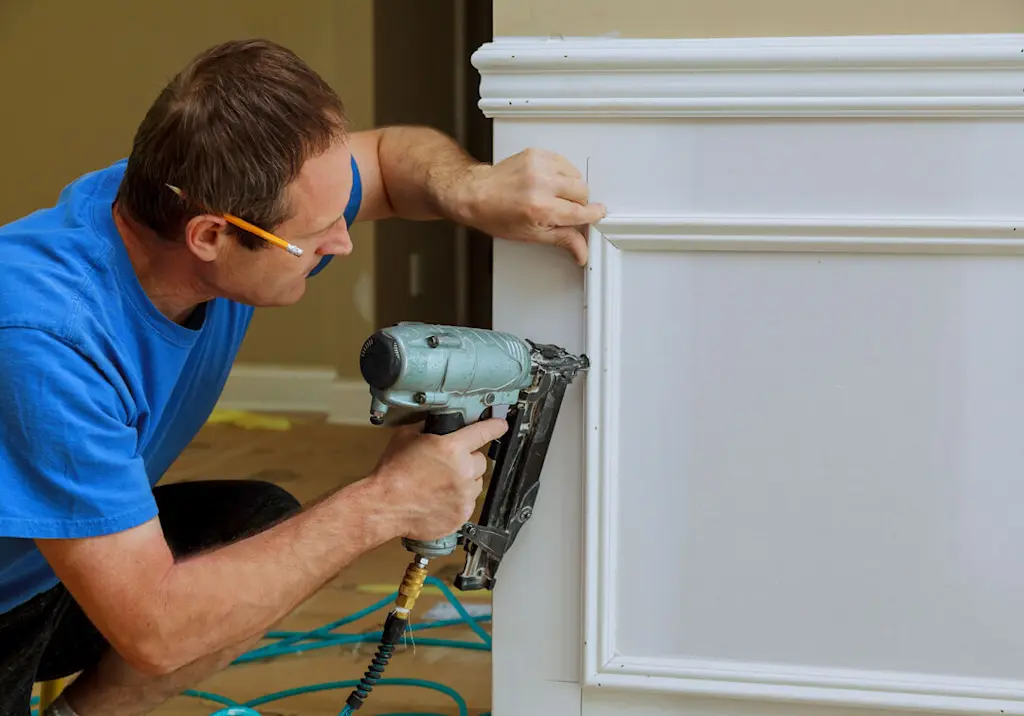 Handyman fixing wall panelling resized