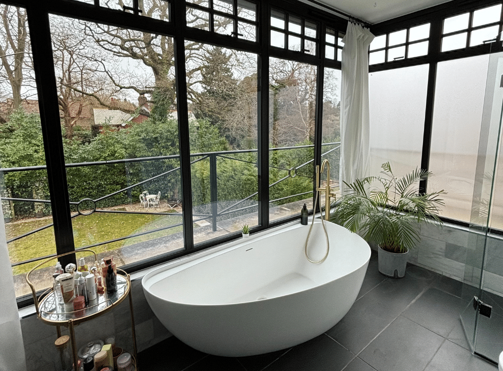 The House with the Blue Shutters features a contemporary freestanding bath in the fully-glazed guest ensuite
