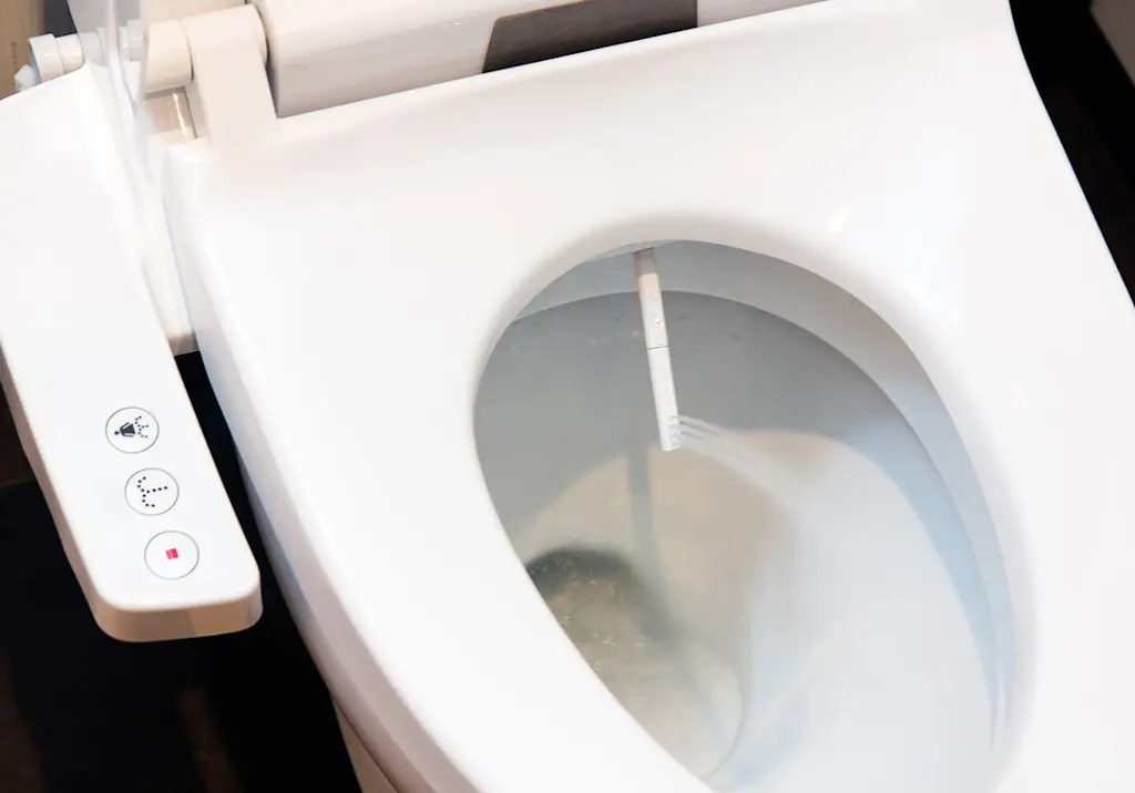 Bidet toilet spray wand in use smart japanese toilet