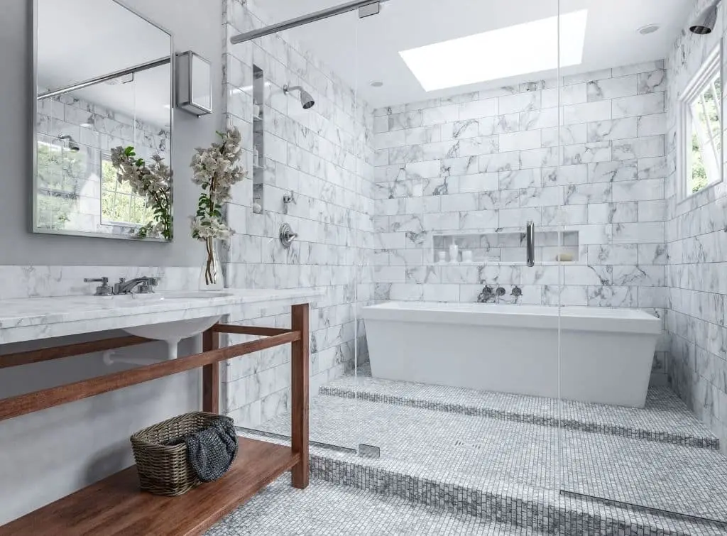 White mosaic floor tiles in a wet room with white, grey, and silver accents