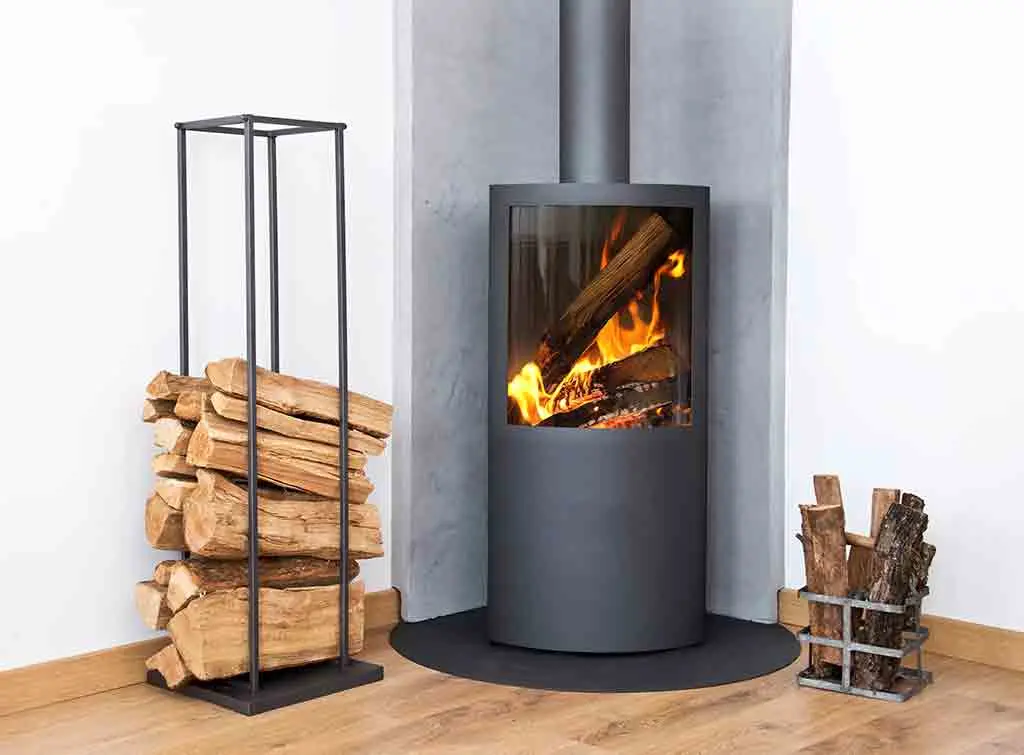 https://www.checkatrade.com/blog/wp-content/uploads/2020/11/Corner-wood-stove-design-ideas.jpg