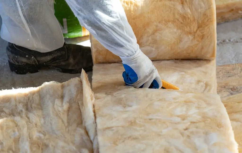 Loft insulation installer at work