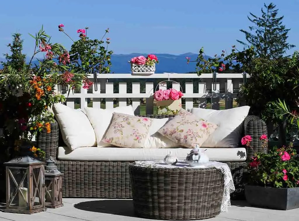 A flat roof decorated with outdoor rattan furniture