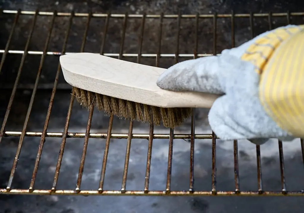 Cleaning metal grill on barbeque