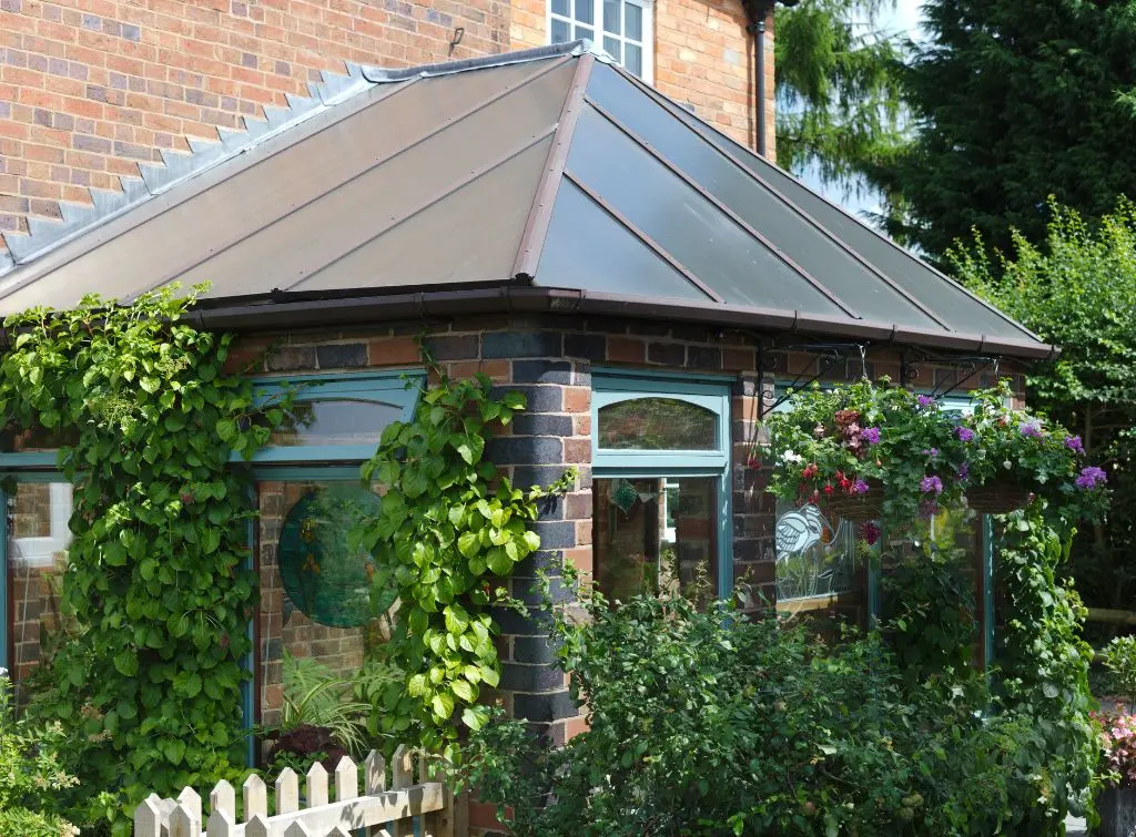 English garden with vine plants growing on a conservatory