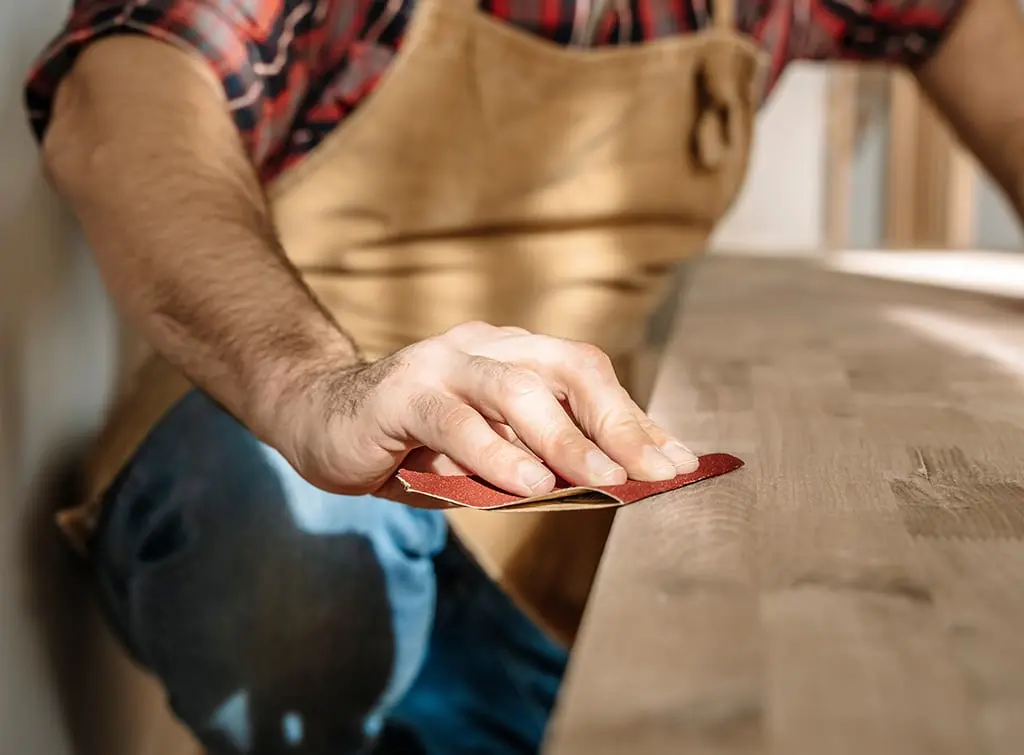 Cabinet maker sanding wood