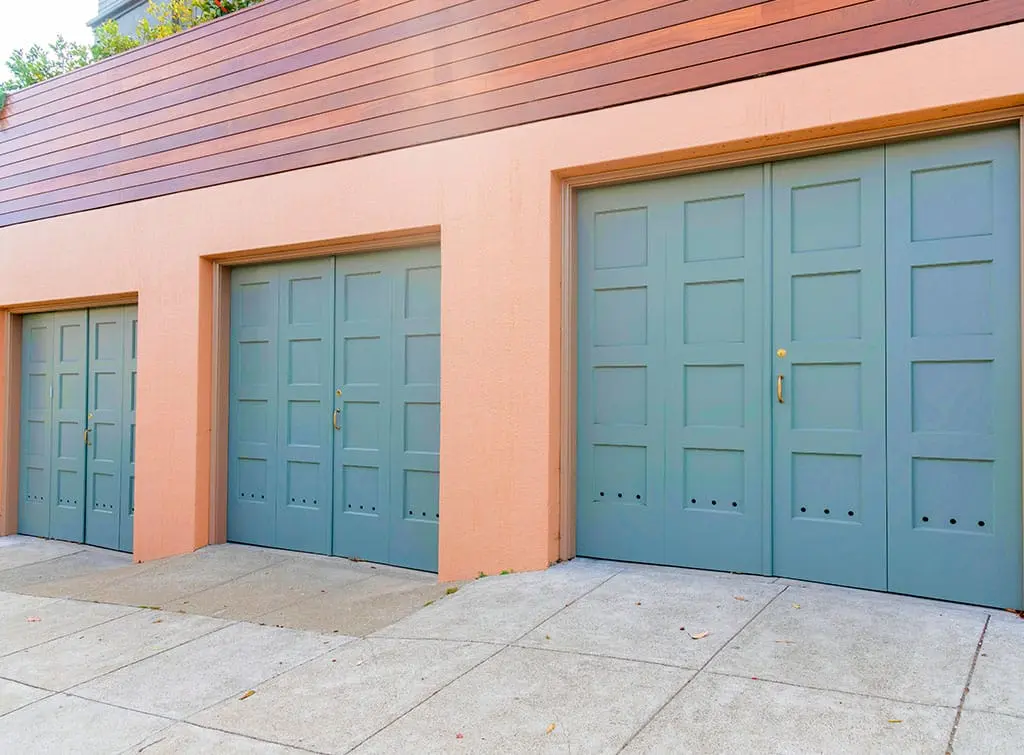 https://www.checkatrade.com/blog/wp-content/uploads/2023/09/garage-door-conversions-blue-doors.jpg