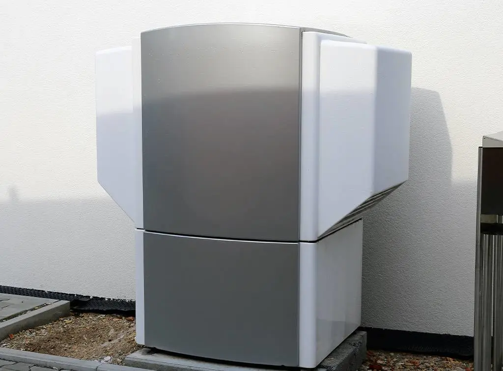 Air source heat pump installed outside house