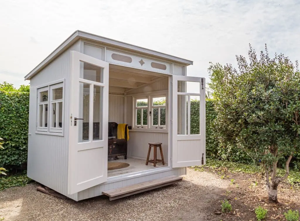 The Scandi style small shed with white walls and minimalist furniture