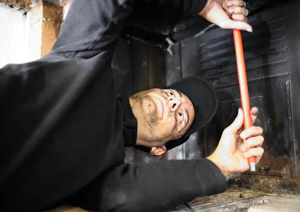 chimney sweep working indoors
