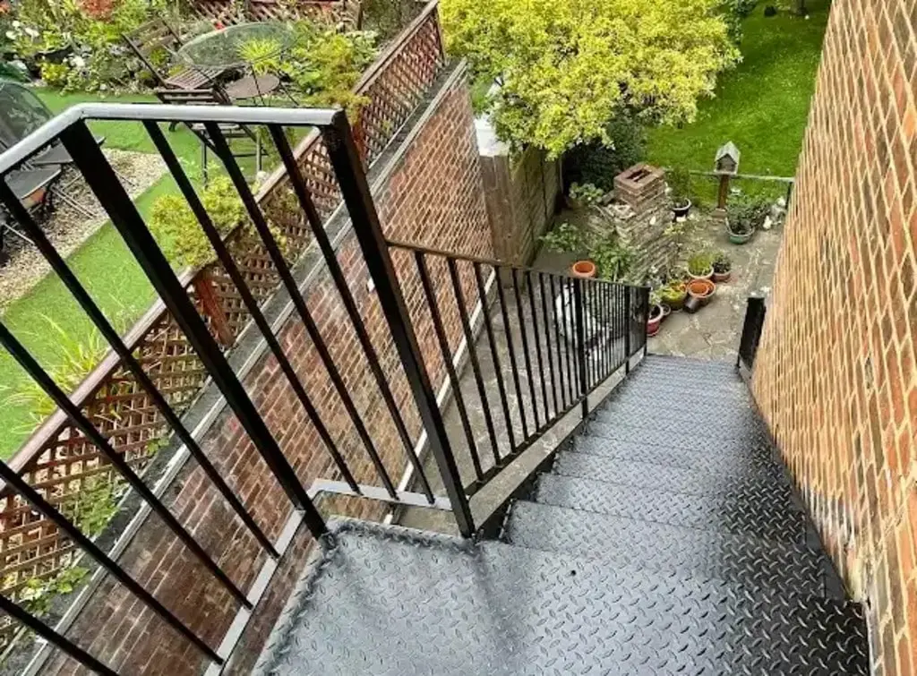 Black metal outdoor staircase by Kutch Engineering