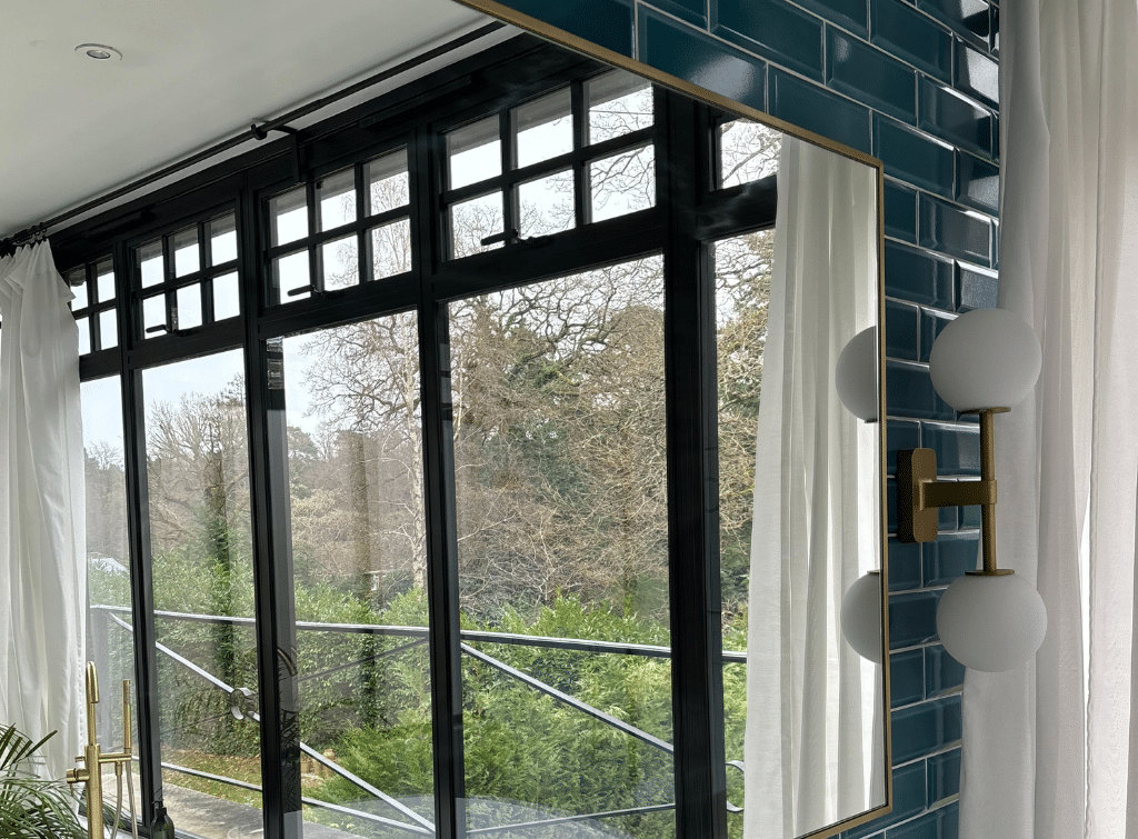 The glass extension in the House with the Blue Shutters allows uninterrupted views of the outside space