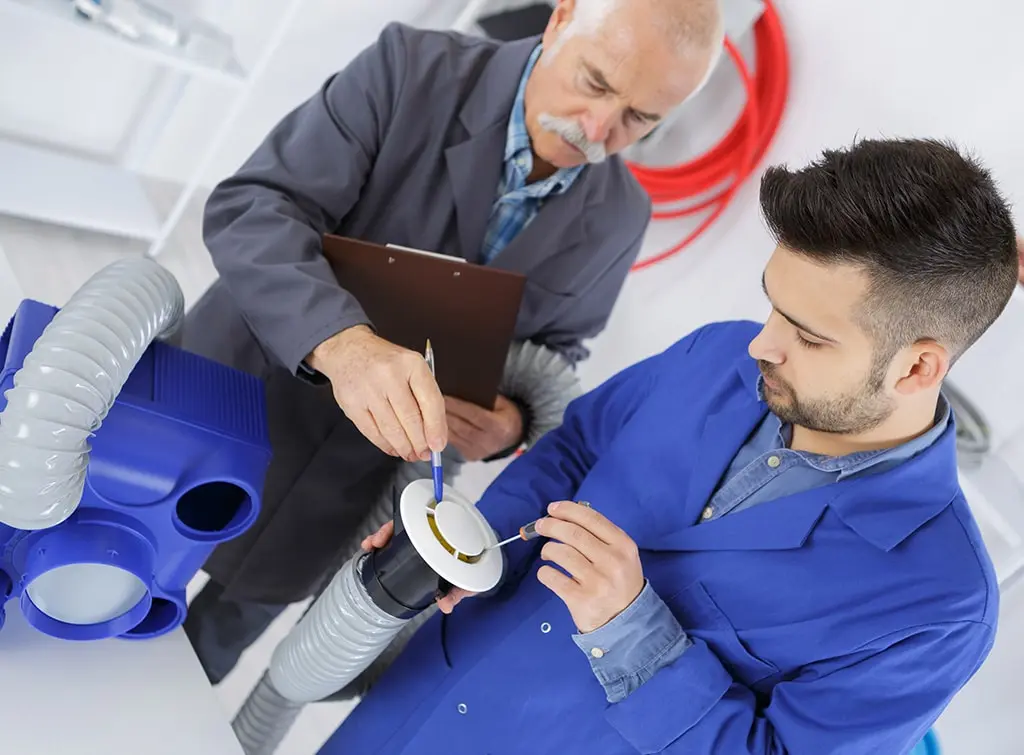 https://www.checkatrade.com/blog/wp-content/uploads/2024/02/plumber-training-hose-inspection.jpg