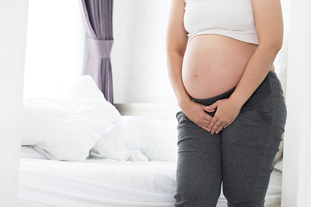 Pregnant mom-to-be getting out of bed to pee