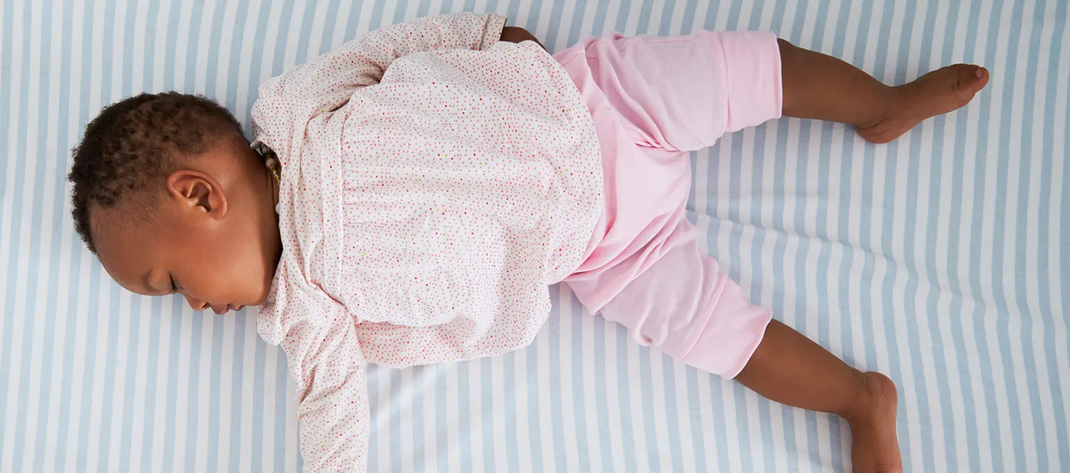 Baby sleeping on back to reduce risk of SIDS