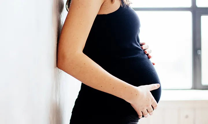 Pregnant women holding belly