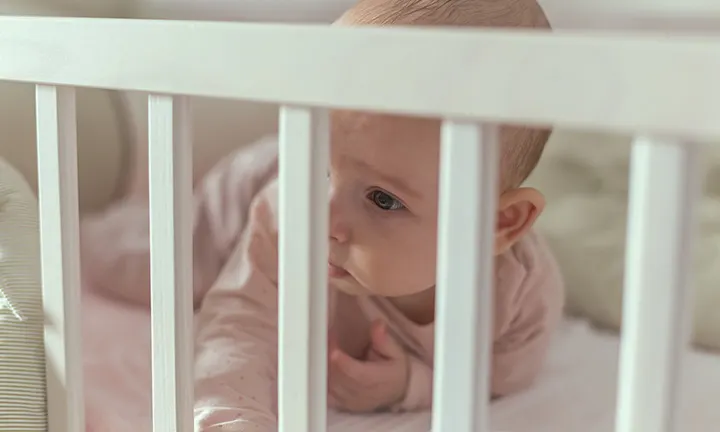 Baby in crib during Ferber Method sleep training