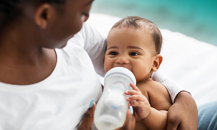 When Do Babies Hold Their Own Bottle or Cup? | Pampers