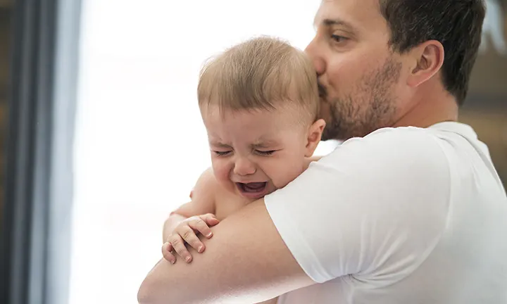 Baby crying with dad