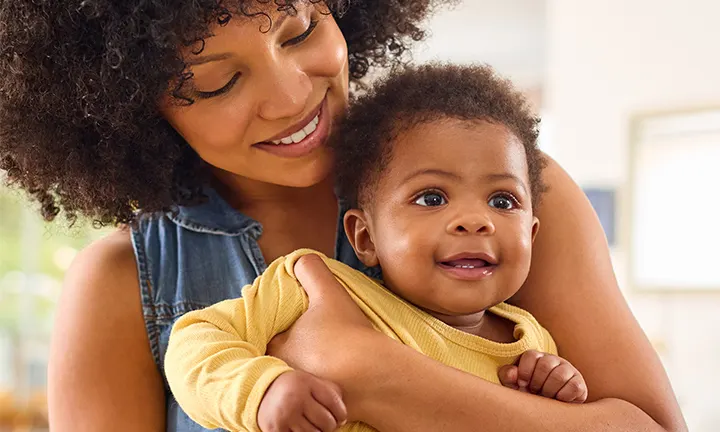 Mom holding her baby in her arm
