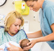 Mother and nurse holding newborn baby