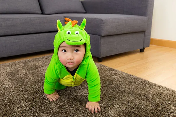 Baby in adorable dinosaur halloween costume