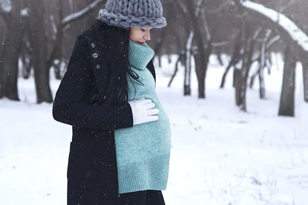 Pregnant woman takes a walk in the snow
