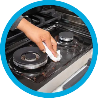 Mr. Clean wipe cleaning dirt from a stovetop