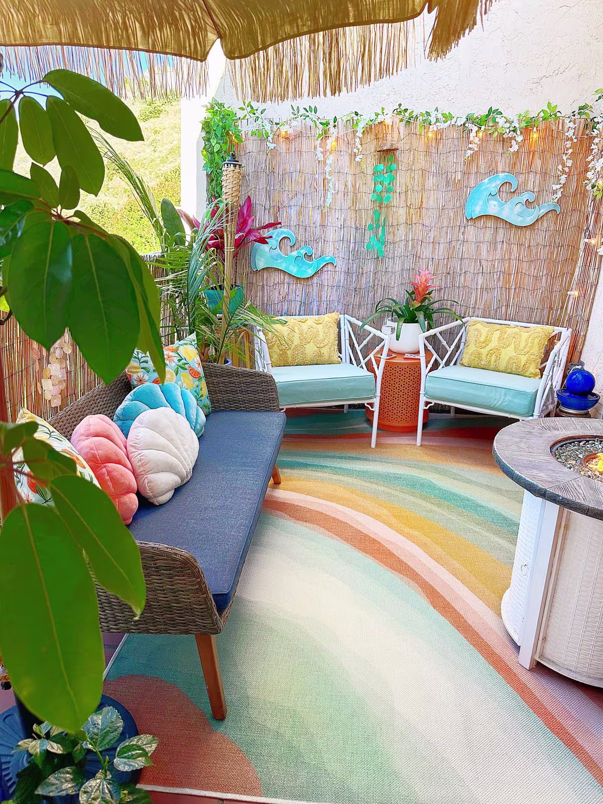 Ruggable Outdoor Watercolor Waves Copper Jade Rug in tropical outdoor patio setting with house plants and outdoor furniture 